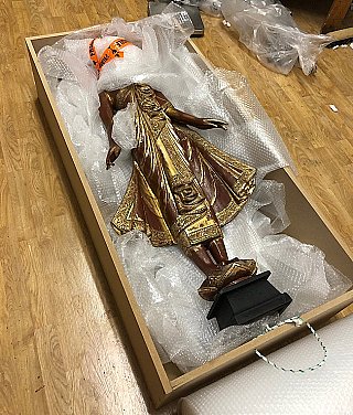 Buddha statue in wooden crate