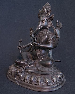 Ganesha bronze statue from India in three-quarter view, showing the axe and lotus stem