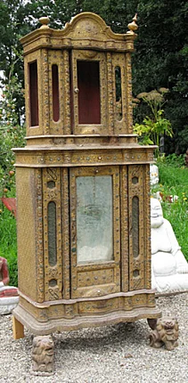 Antique wooden Burmese temple shrine, three-quarter view with glass panel and lion feet