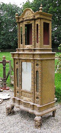 Mandalay-period wooden Burmese temple shrine, angled view showing corner columns and open upper niche