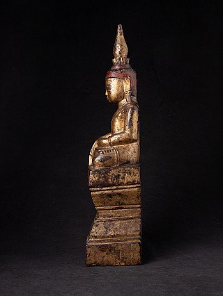 Burmese Shan Buddha statue in wood, seated side profile with the tiered base