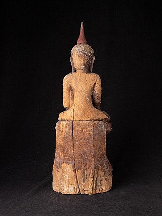 Antique Burmese wooden Buddha statue, rear view with visible wood grain and wear