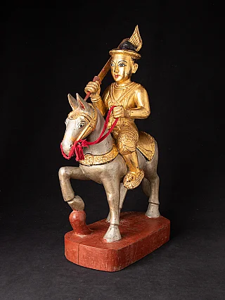 Burmese Nat statue on a horse in painted wood, three-quarter view with raised sword