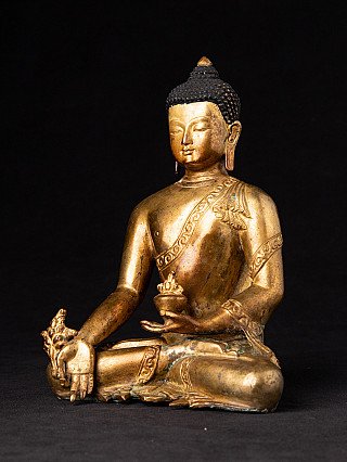 Bronze-Statue des Medizin-Buddha aus Nepal in Dreiviertelansicht, sitzend mit Schale und gesenkter Hand
