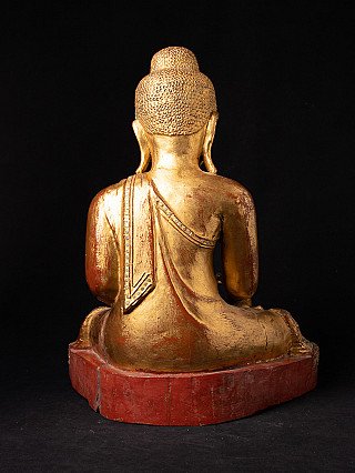 Seated Mandalay Buddha statue in wood, rear view showing elongated earlobes