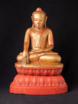 Burmese wooden Buddha statue seated on a red lotus base, full front view