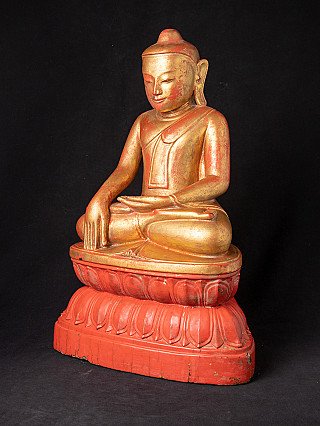 Burmese wooden Buddha statue in bhumisparsha mudra, three-quarter left view