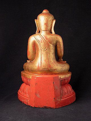 Burmese wooden Buddha statue, rear view showing robe lines across the back