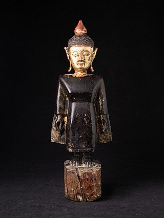 Tai Lue Buddha statue from Laos in wood, standing full-front on a rough block base