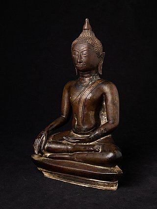 Thai bronze Buddha statue in three-quarter view showing the base