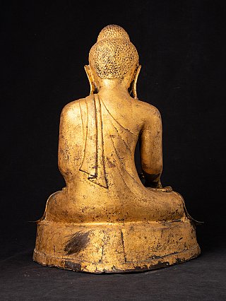 Antique Mandalay Buddha statue in bronze, rear view showing the robe drape over the back