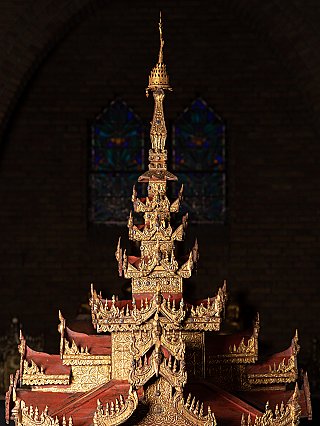 Upper structure of the wooden temple shrine with tall gilded spire, front view