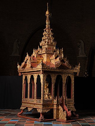 Wooden temple shrine from Burma (Myanmar), three-quarter view showing seated figure inside