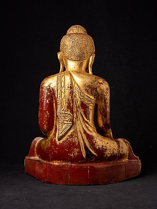 Burmese wooden Buddha statue, rear view showing red lacquered back and robe folds