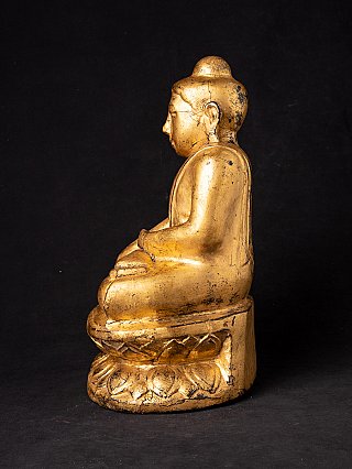 Seated Burmese wooden Buddha statue, side profile view showing worn gilding