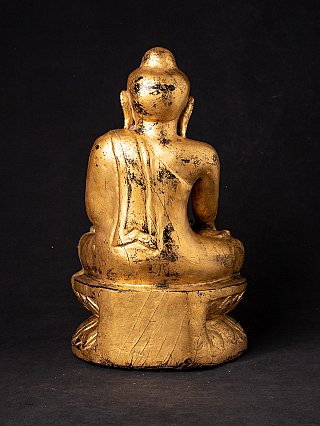 Rear view of the antique Burmese wooden Buddha statue, showing wear on back and head