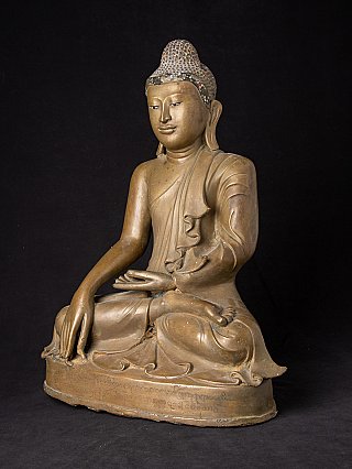 Bronze Buddha statue from Burma (Myanmar) in three-quarter view, right hand reaching down