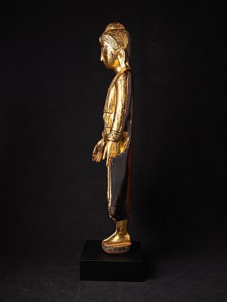 Burmese wooden Buddha statue in Mandalay style, side profile view