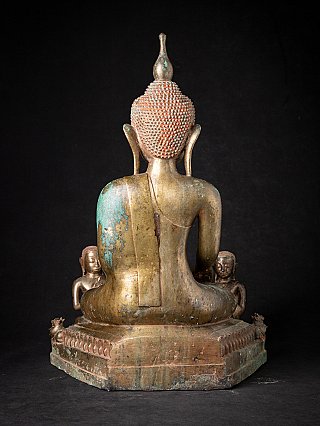 Burmese bronze Buddha statue, rear view with the two monks partly visible