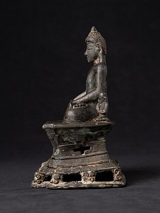 Arakan bronze Buddha statue, left side profile with small attendant figure on the platform