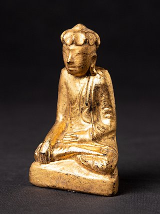 Burmese wooden Buddha statue in seated posture, three-quarter left view on base