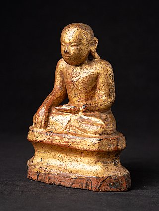 Wooden monk statue from Burma (Myanmar), three-quarter left view showing worn gilded surface