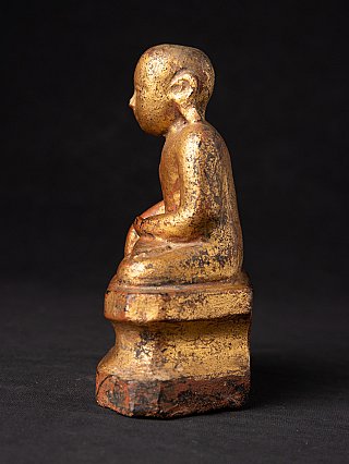 Burmese wooden monk statue, left side profile showing ear and stepped base