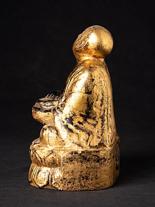 Wooden monk statue from Burma (Myanmar), left side view with tilted head