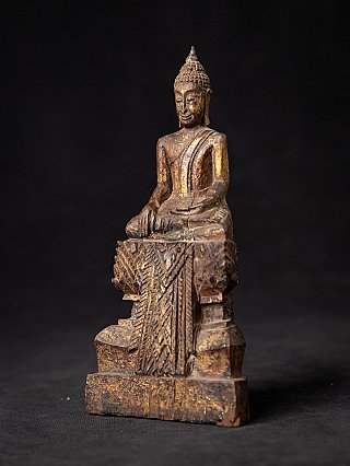 Wooden Thai Buddha statue in bhumisparsha mudra, three-quarter view with stepped base