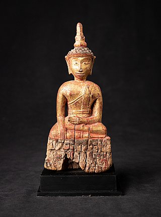 Antique Thai Buddha statue in wood, seated in bhumisparsha mudra, full front view