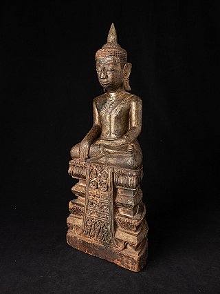 Thai wooden Buddha statue seated on stepped base, three-quarter view with front panel