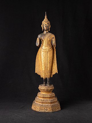 Thai bronze Buddha statue standing in Abhaya mudra, full-front view on tiered base