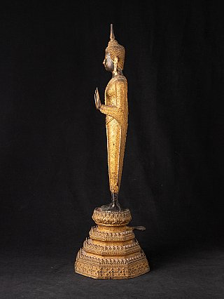 Standing Thai bronze Buddha statue, left side profile with raised hands