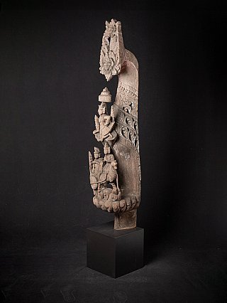 Wooden temple panel from Myanmar, three-quarter view showing pierced scrollwork and small figures