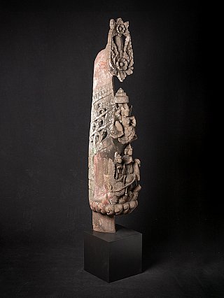 Antique wooden temple panel from Burma (Myanmar), three-quarter view with carved figures and floral crest
