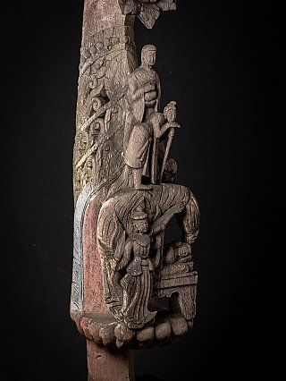 Detail of the relief scene on the wooden temple panel with multiple figures