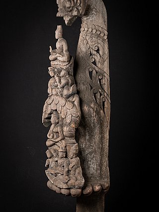 Detail of the upper relief figures with the carved scrolling motif along the side