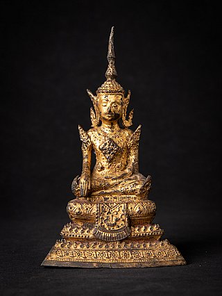 Thai bronze Buddha statue seated, full front view on ornate tiered base