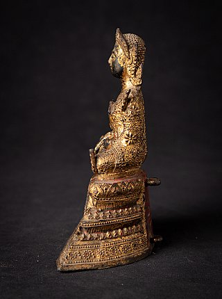 Thai bronze Buddha statue seated, left side profile with tall tiered base