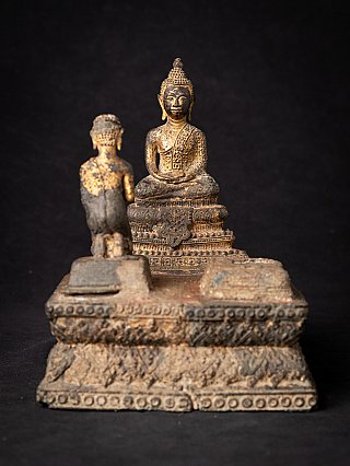 Thai bronze Buddha statue with kneeling monk on an ornate base, front view