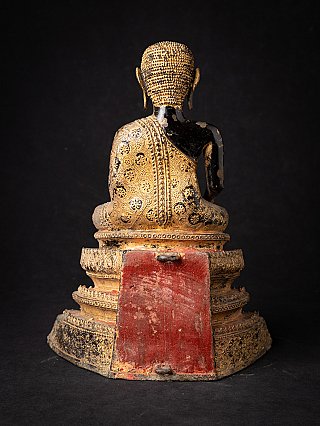 Thai bronze monk statue, rear view with red panel on the base and worn surface