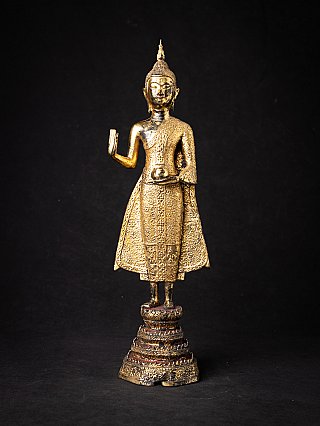 Thai bronze Buddha statue standing in Abhaya mudra, full front view on tiered base