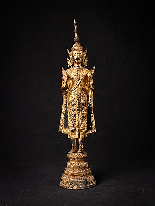 Thai bronze Buddha statue standing in Abhaya mudra, full front view on tiered base