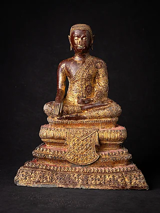 Thai bronze monk statue seated in bhumisparsha mudra, full-front on tiered base