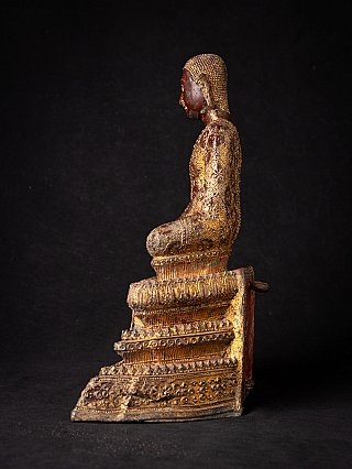 Thai bronze monk statue in left side profile, seated posture on stepped base