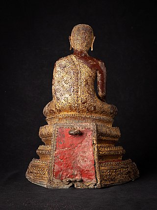 Thai bronze monk statue, rear view with red panel visible on the base
