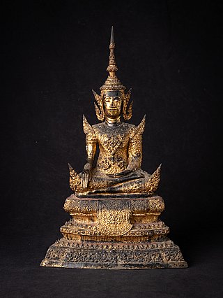 Thai bronze Buddha statue in bhumisparsha mudra on ornate tiered base, full front view