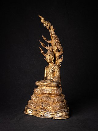 Antique bronze Thai Buddha on Naga snake