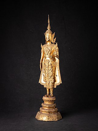 Bronze Buddha statue from Thailand, standing with raised hand, three-quarter view