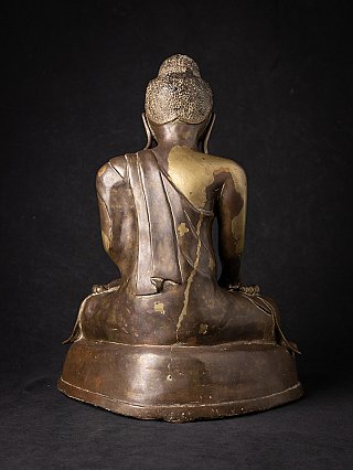 Mandalay bronze Buddha statue, rear view with robe drape and visible wear on the back